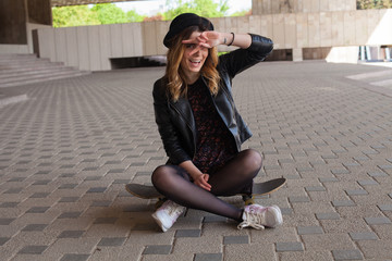 Girl sitting on the skateboard