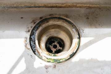 old dirty sink with rusty metal drain
