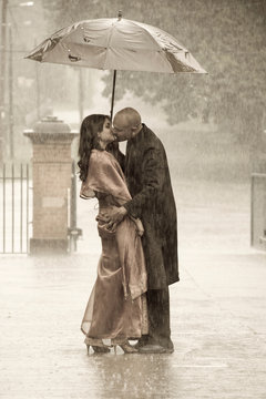 Indian Smartly Dressed Couple Holding An Umbrella In The Rain Ki