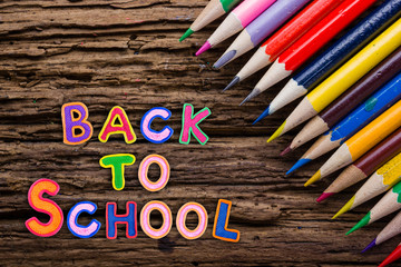 Back to School desk table top view, words on grunge old wooden board background. Education concept. Time for learning.