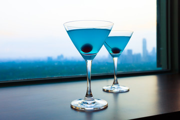 Martini drinks and a city view. 