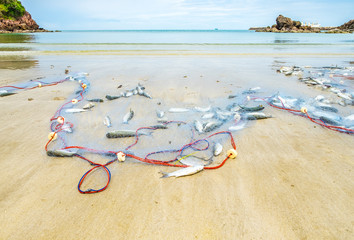 Landscape view of fishing nets catch fish on sand beach and sea