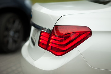 A closeup of red lights of white BMW