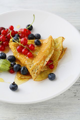 Hot pancake with sauce and berries