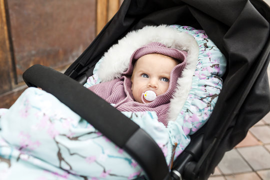 Baby lying in baby stroller