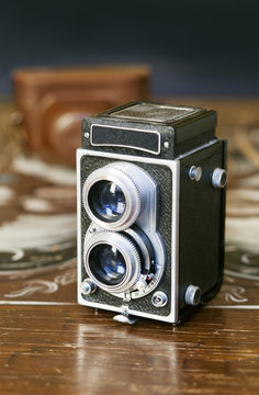 Twin-lens reflex camera on wooden table