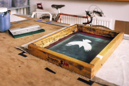Close-up of screen printing frame on table in bag factory