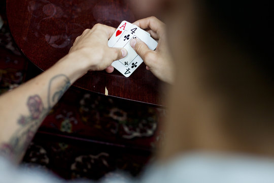 Cropped image of man playing cards at home
