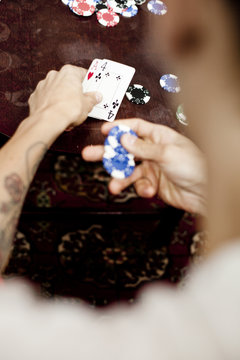 Cropped image of man playing poker at home