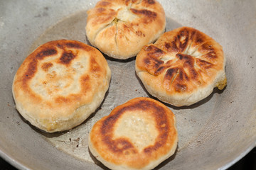four pieces of fried bhatura in pan with selective focus