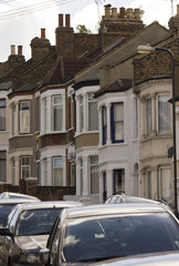 Fototapeta na wymiar LONDON, UNITED KINGDOM - SEPTEMBER 12 2016: Traditional british houses in a row with car parked on the street, in the suburb of Woolwich Arsenal, London