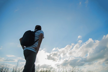 man travelling in nature with backpack