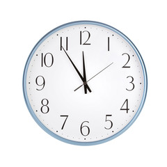 Round clock shows five minutes to twelve