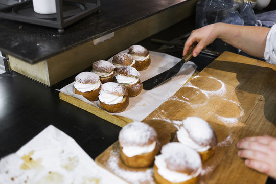 Cropped image of chef placing prepared buns for display