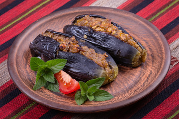 Baked eggplant stuffed with onions, cherry plums and walnuts