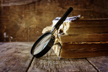 magnifying glass and old book