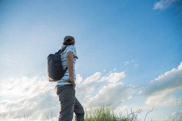man travelling in nature with backpack
