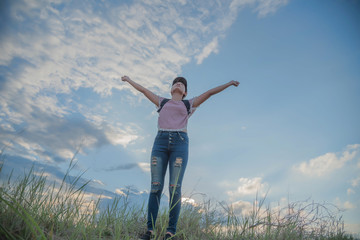 Fototapeta premium cheering young woman hiker open arms to snow mountains in the di