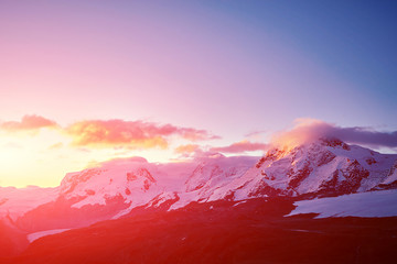Fototapeta na wymiar beautifull cloudy sunrise in the mountains with snow ridge. Alps. Switzerland, Trek near Matterhorn mount.