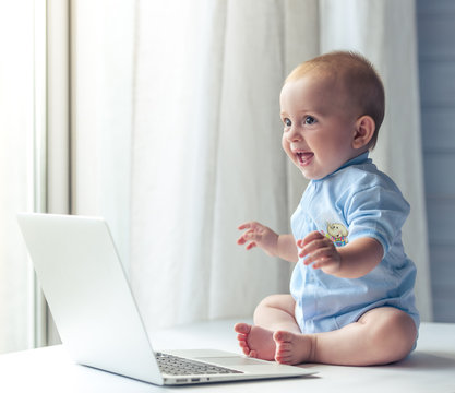 Cute baby with laptop