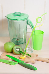 Cooking smoothie of kiwi, apple, lemon and mint. Blender, knife,