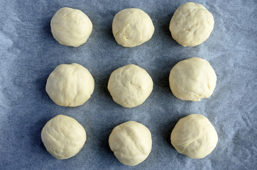 Flat lay view of round pieces of Bread Rolls dough