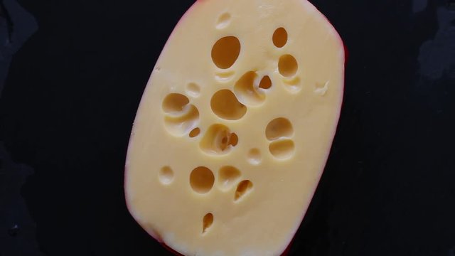 Rotating Piece Of Yellow Porous Cheese  