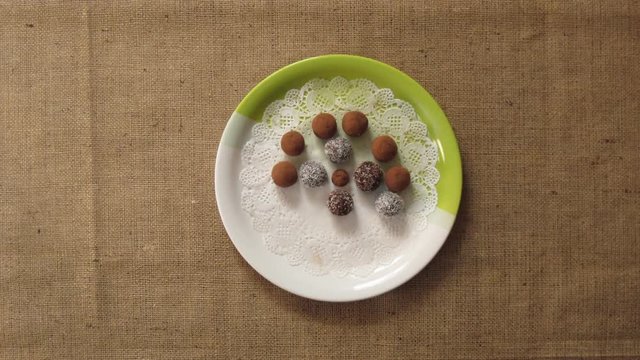 Round home made sweets appears on a plate. Stop motion animation
