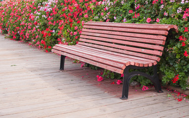 wooden bench with flowers in the background