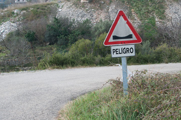 warning sign on a winding road