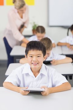 Portrait of schoolboy using digital tablet