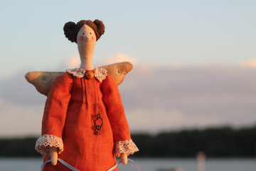Handmade fabric textile soft doll toy tilda angel girl in orange dress with brown hair and wings