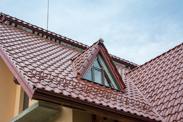 Red metallic roof with attic and snow guards