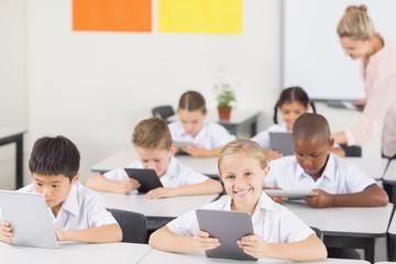 Students using digital tablet in classroom