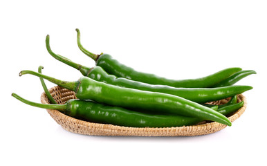 Green chilli pepper in basket on white background