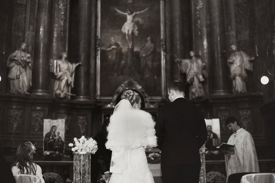 Black and white picture made from behind the wedding couple duri