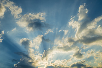 Fototapeta na wymiar Sunbeam through the clouds on blue sky: can be used as background