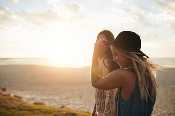 Female friends walking on the sea shore