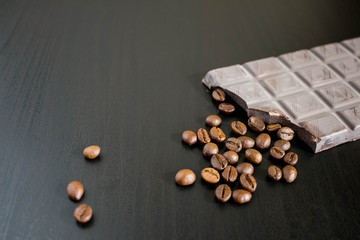 dark chocolate and coffee beans on old wooden table