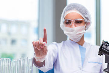 Young student working with chemical solutions in lab