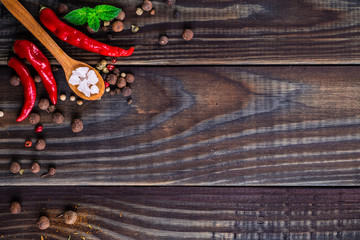 Powder spices on spoons in black wooden table background