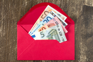 Red envelope with Euro bills.