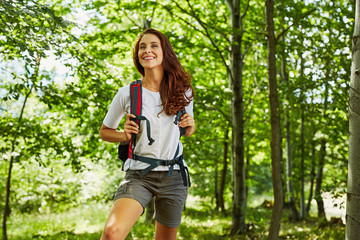 Happy woman hiking in the woods