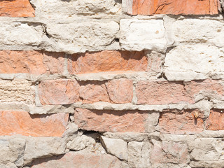 Old rough wall with red bricks