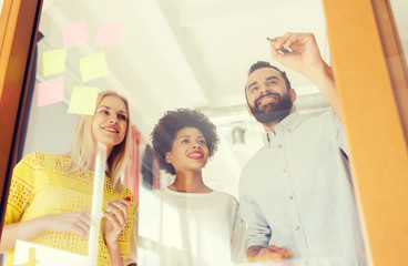 Fototapeta premium happy creative team writing on stickers at office