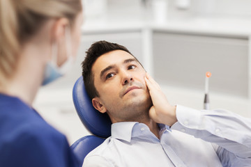 female dentist and male patient with toothache