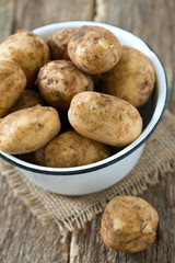 potatoes on wooden surface