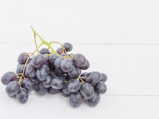 Purple grapes on wooden table