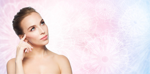 Naklejka premium beautiful young woman touching her face