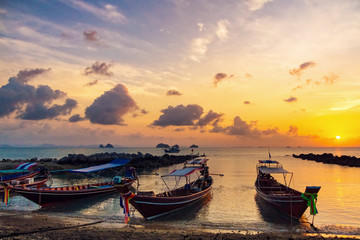 Fototapeta premium Fishing boats on the beach at sunset background